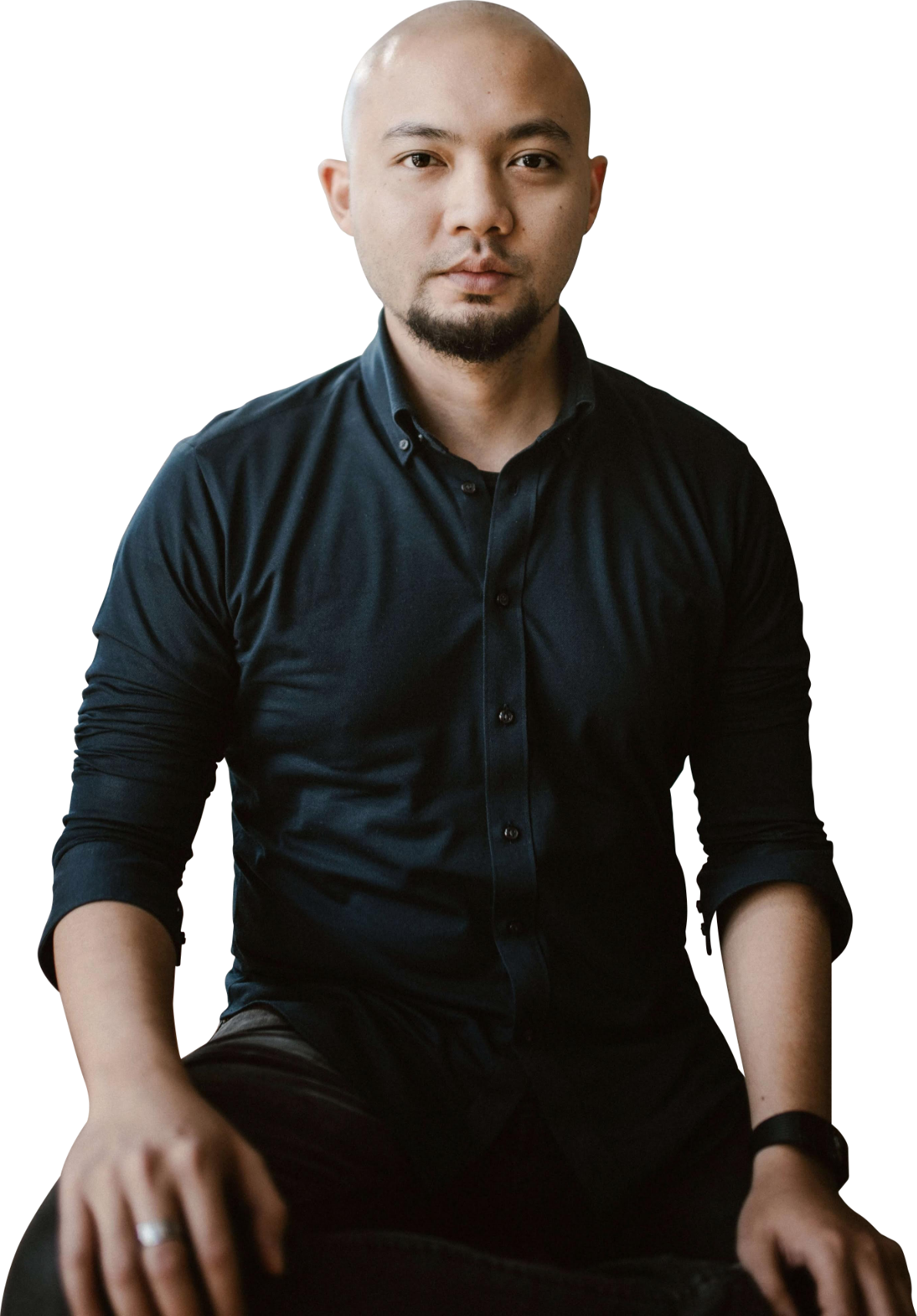 Tri Lastiko, seated in a black shirt